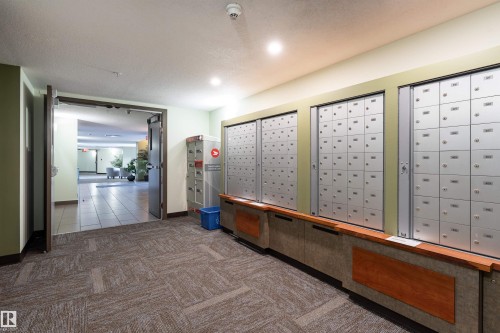 Reception area featuring mail area and a textured ceiling - 101 6220 134 Avenue, Edmonton, AB - Indoor Photo Showing Other Room