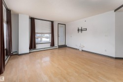 Spare room with light wood-style flooring, a baseboard heating unit, and a textured ceiling - 