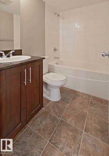 Full bathroom featuring vanity, shower / bathtub combination, and a textured ceiling - 404 5370 Chappelle Road, Edmonton, AB - Indoor Photo Showing Bathroom