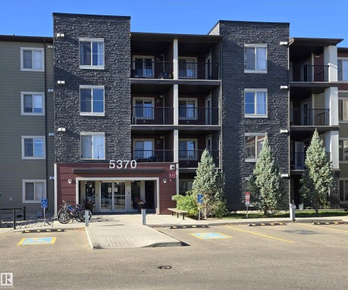 View of apartment building / complex featuring uncovered parking - 404 5370 Chappelle Road, Edmonton, AB - Outdoor With Balcony With Facade