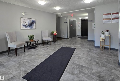 Building lobby featuring a textured ceiling - 404 5370 Chappelle Road, Edmonton, AB - Indoor Photo Showing Other Room