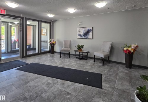 Common area featuring a textured ceiling - 404 5370 Chappelle Road, Edmonton, AB - Indoor Photo Showing Other Room