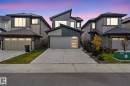 Contemporary home with a garage, concrete driveway, and board and batten siding - 1813 Collip View View, Edmonton, AB  - Outdoor 