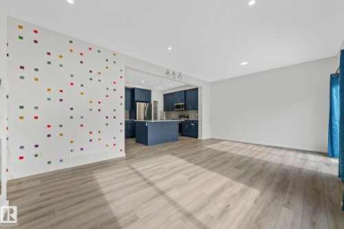 Unfurnished living room with light wood-type flooring and recessed lighting - 1813 Collip View View, Edmonton, AB - Indoor