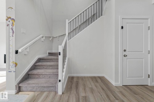 Staircase featuring wood finished floors and baseboards - 1813 Collip View View, Edmonton, AB - Indoor Photo Showing Other Room