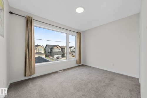 Empty room with light colored carpet and baseboards - 1813 Collip View View, Edmonton, AB - Indoor