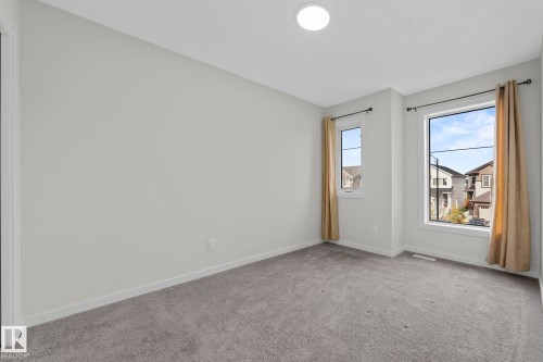 Empty room with light carpet and baseboards - 1813 Collip View View, Edmonton, AB - Indoor Photo Showing Other Room