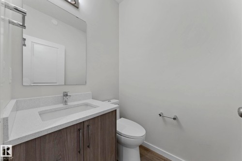 Half bathroom with vanity and wood finished floors - 1813 Collip View View, Edmonton, AB - Indoor Photo Showing Bathroom