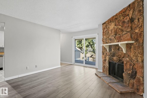 329 10404 24 Avenue, Edmonton, AB - Indoor Photo Showing Living Room With Fireplace