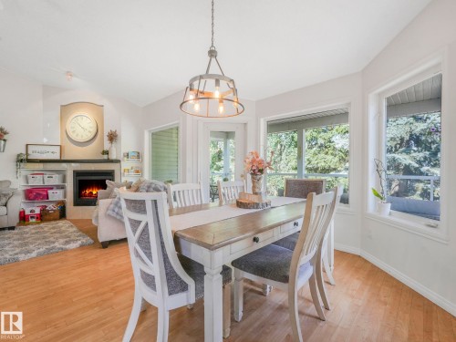 138 Pipestone Manor, Millet, AB - Indoor Photo Showing Dining Room With Fireplace