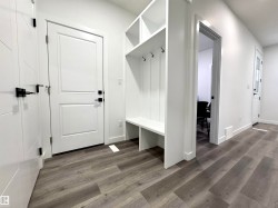 Mudroom with dark wood-type flooring - 
