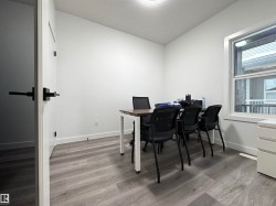 Office with a textured ceiling and light wood-style floors - 