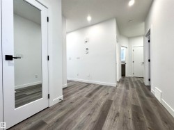 Hall featuring dark wood-style floors, recessed lighting, and a textured ceiling - 