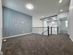 Empty room featuring a textured ceiling, dark colored carpet, and recessed lighting - 