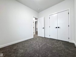 Unfurnished bedroom with dark carpet, a closet, and a textured ceiling - 