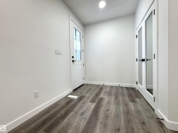 Foyer with dark wood finished floors and a textured ceiling - 
