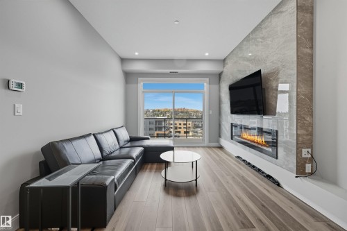 619 7463 May Common, Edmonton, AB - Indoor Photo Showing Living Room With Fireplace