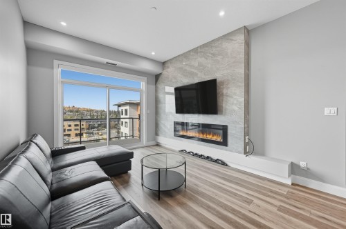 619 7463 May Common, Edmonton, AB - Indoor Photo Showing Living Room With Fireplace