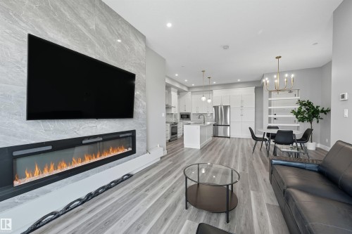 619 7463 May Common, Edmonton, AB - Indoor Photo Showing Living Room With Fireplace