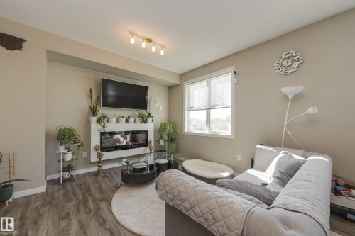31 2803 James Mowatt Trail, Edmonton, AB - Indoor Photo Showing Living Room With Fireplace