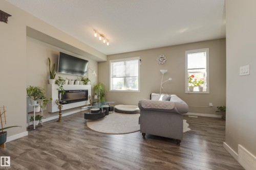31 2803 James Mowatt Trail, Edmonton, AB - Indoor Photo Showing Living Room With Fireplace