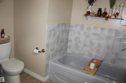 Bathroom with a bath and tile patterned flooring - 