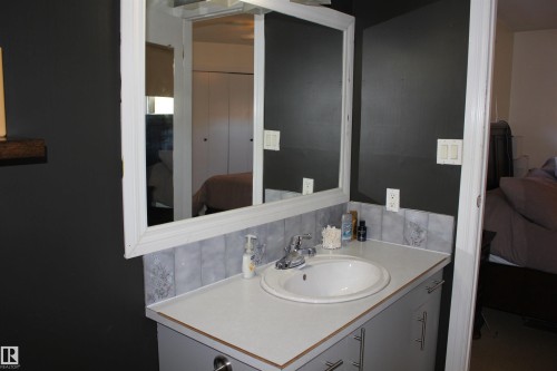 Ensuite bathroom featuring vanity and tasteful backsplash - 5221 54A Street, Elk Point, AB - Indoor Photo Showing Bathroom