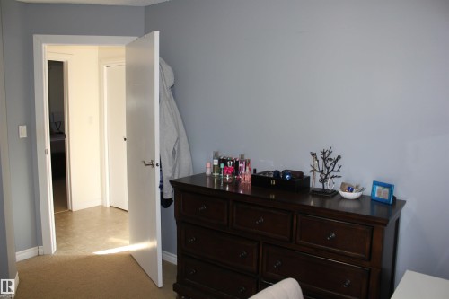 Bedroom featuring baseboards and light carpet - 5221 54A Street, Elk Point, AB - Indoor