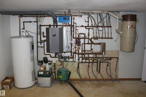Utilities with water heater - 5221 54A Street, Elk Point, AB - Indoor Photo Showing Basement