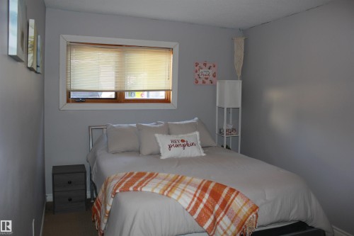 Bedroom featuring baseboards - 5221 54A Street, Elk Point, AB - Indoor Photo Showing Bedroom