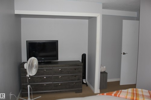 Bedroom with baseboards and carpet - 5221 54A Street, Elk Point, AB - Indoor Photo Showing Other Room