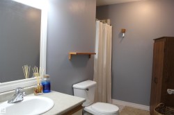 Bathroom featuring vanity, light tile patterned flooring, and a shower with shower curtain - 