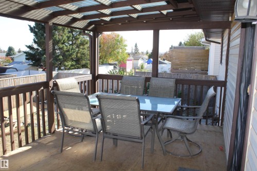 Wooden deck with outdoor dining area - 5221 54A Street, Elk Point, AB - Outdoor With Deck Patio Veranda With Exterior