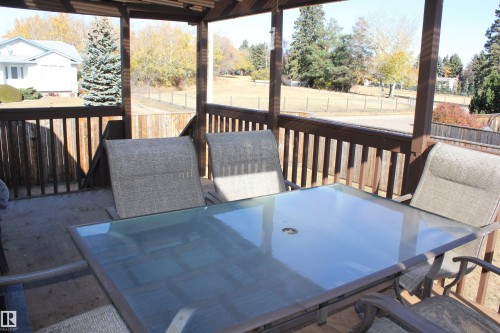 Wooden terrace with outdoor dining area - 5221 54A Street, Elk Point, AB - Outdoor With Deck Patio Veranda With Exterior