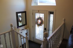 Entrance foyer with healthy amount of natural light and stairway - 
