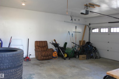 Garage featuring a garage door opener - 5221 54A Street, Elk Point, AB - Indoor Photo Showing Garage