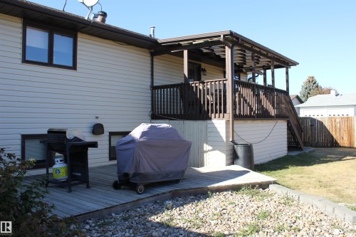 Wooden terrace with grilling area and stairs - 5221 54A Street, Elk Point, AB - Outdoor With Exterior