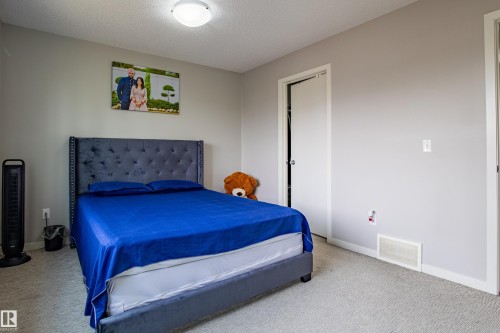 Bedroom with carpet and a textured ceiling - 2407 Casey Link, Edmonton, AB - Indoor Photo Showing Bedroom