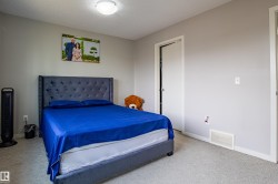 Bedroom with carpet and a textured ceiling - 