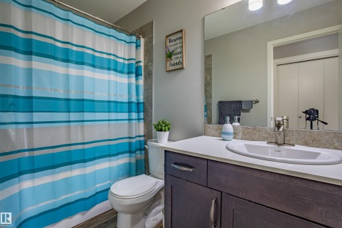 Bathroom with vanity and a textured ceiling - 2407 Casey Link, Edmonton, AB - Indoor Photo Showing Bathroom