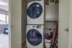 Washroom with cabinet space and stacked washing machine and dryer - 