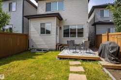 Rear view of property with a fenced backyard and a deck - 