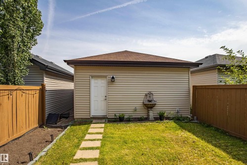 Back of house featuring a fenced backyard and roof with shingles - 2407 Casey Link, Edmonton, AB - Outdoor With Exterior