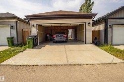 Garage featuring concrete driveway - 