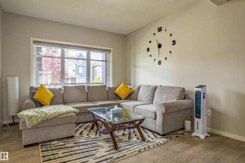 Living room featuring wood finished floors and a textured ceiling - 2407 Casey Link, Edmonton, AB - Indoor Photo Showing Living Room