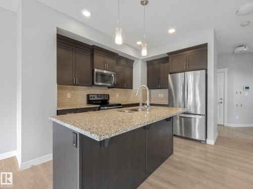 557 Sturtz Link, Leduc, AB - Indoor Photo Showing Kitchen With Stainless Steel Kitchen With Double Sink With Upgraded Kitchen