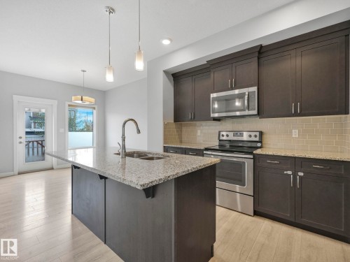 557 Sturtz Link, Leduc, AB - Indoor Photo Showing Kitchen With Stainless Steel Kitchen With Double Sink With Upgraded Kitchen