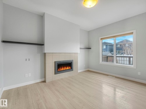 557 Sturtz Link, Leduc, AB - Indoor Photo Showing Living Room With Fireplace