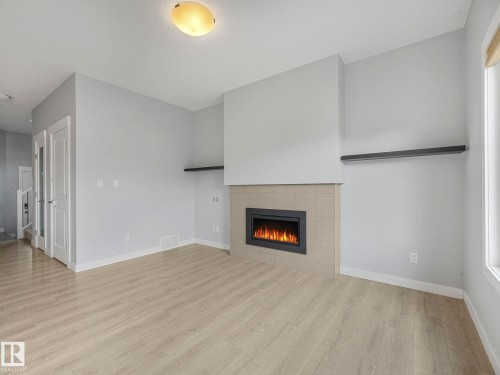 557 Sturtz Link, Leduc, AB - Indoor Photo Showing Other Room With Fireplace