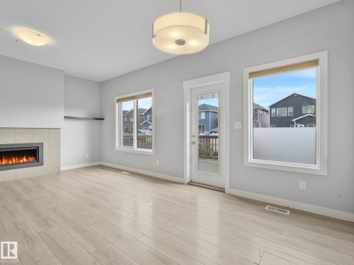 557 Sturtz Link, Leduc, AB - Indoor Photo Showing Other Room With Fireplace